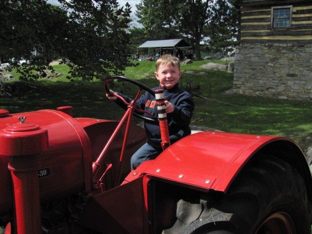 photo from mill day of little boy on tractor