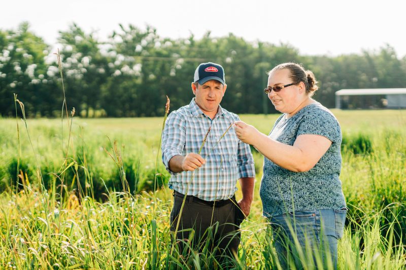 researcher in field with grower