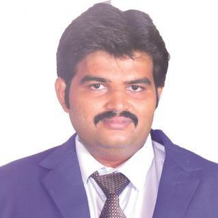 Headshot of a man with dark hair and mustache wearing a blue blazer.