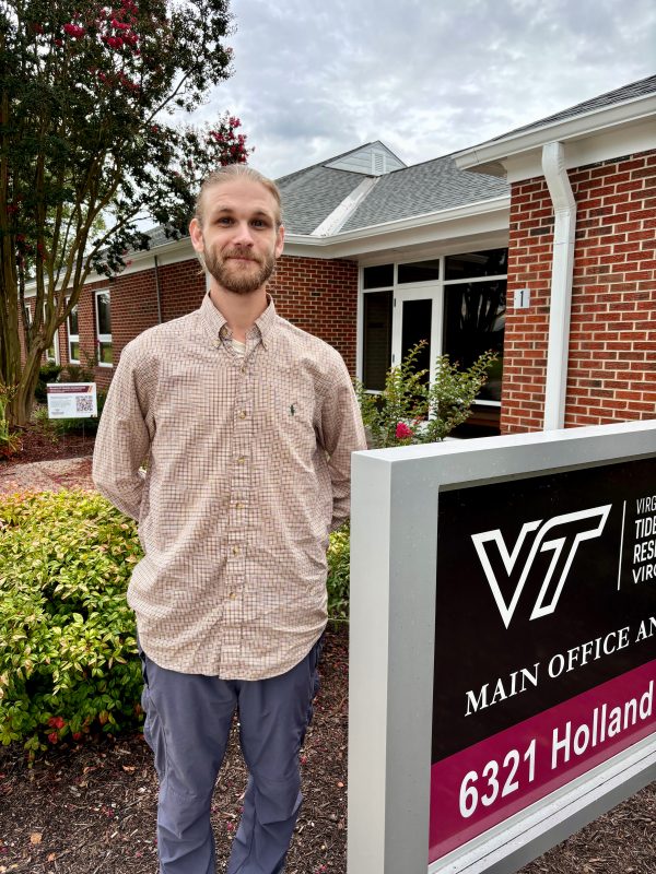 Young man standing in front of administration building at Tidewater AREC.