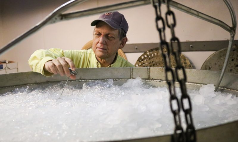 Extension specialist holding a thermometer