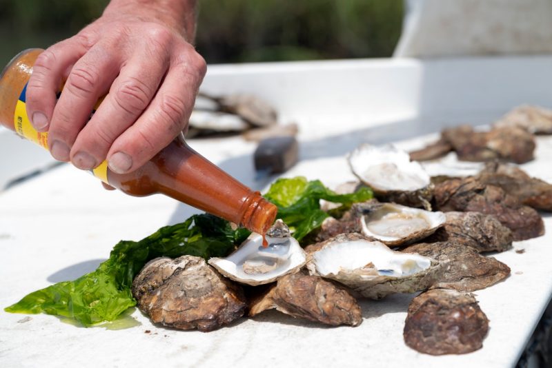 Sauce is poured over steamed oysters