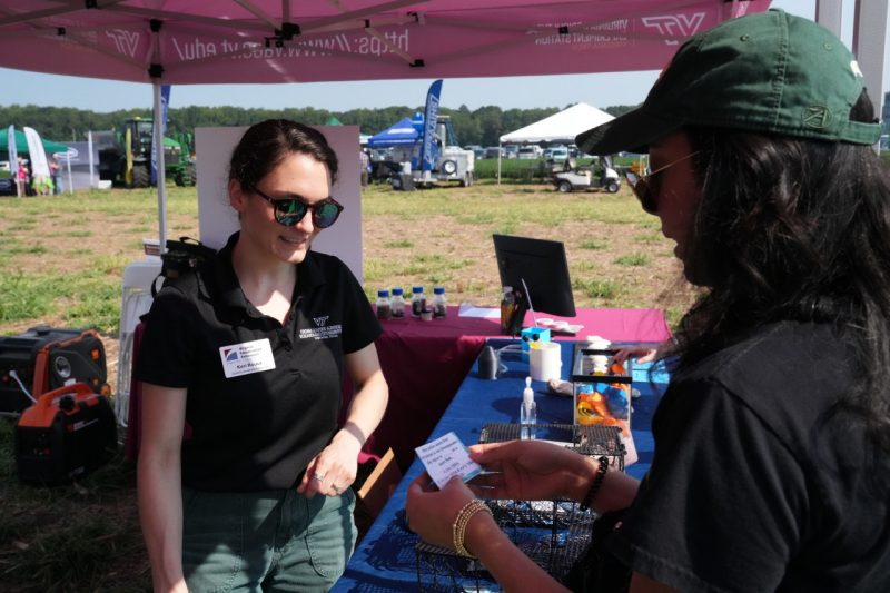 Attendees visit VSAREC booth.