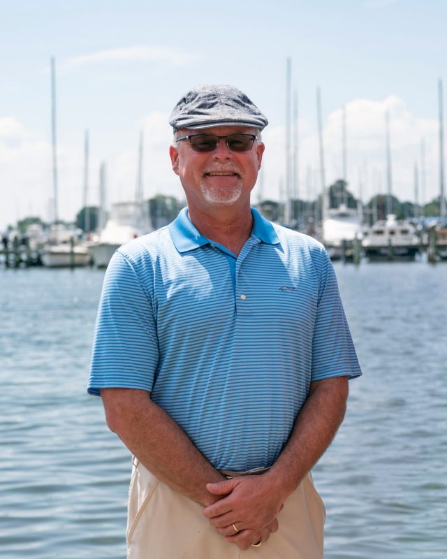 Michael Schwarz stands in front of the Hampton River and boats.