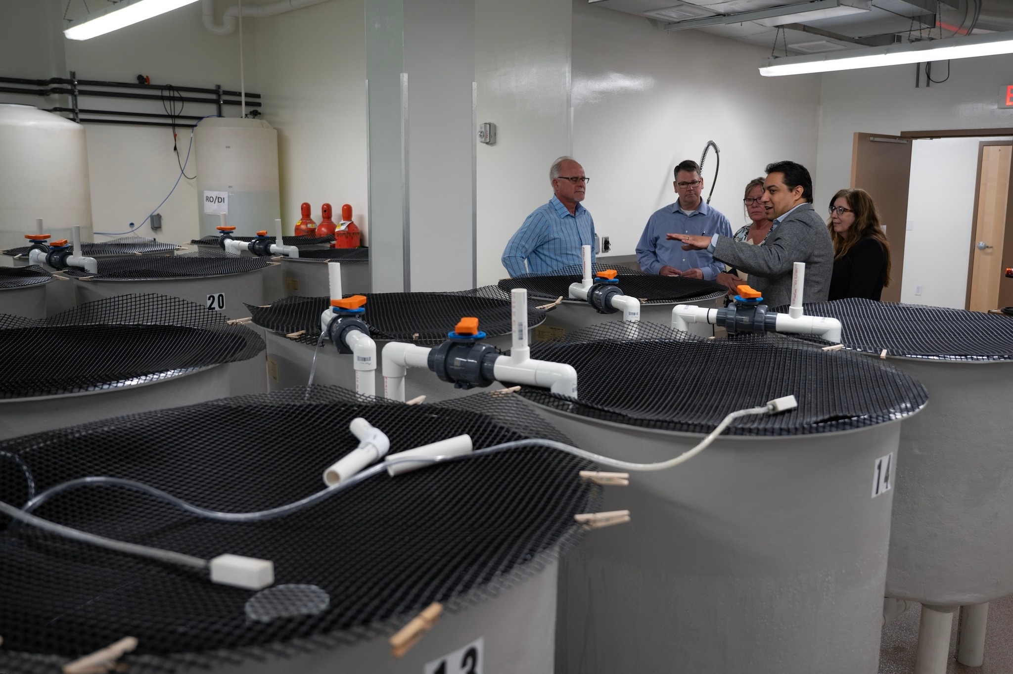Researchers in a facility with vats
