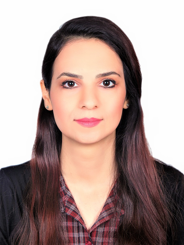 Woman with long dark hair wearing plaid blouse and black blazer.