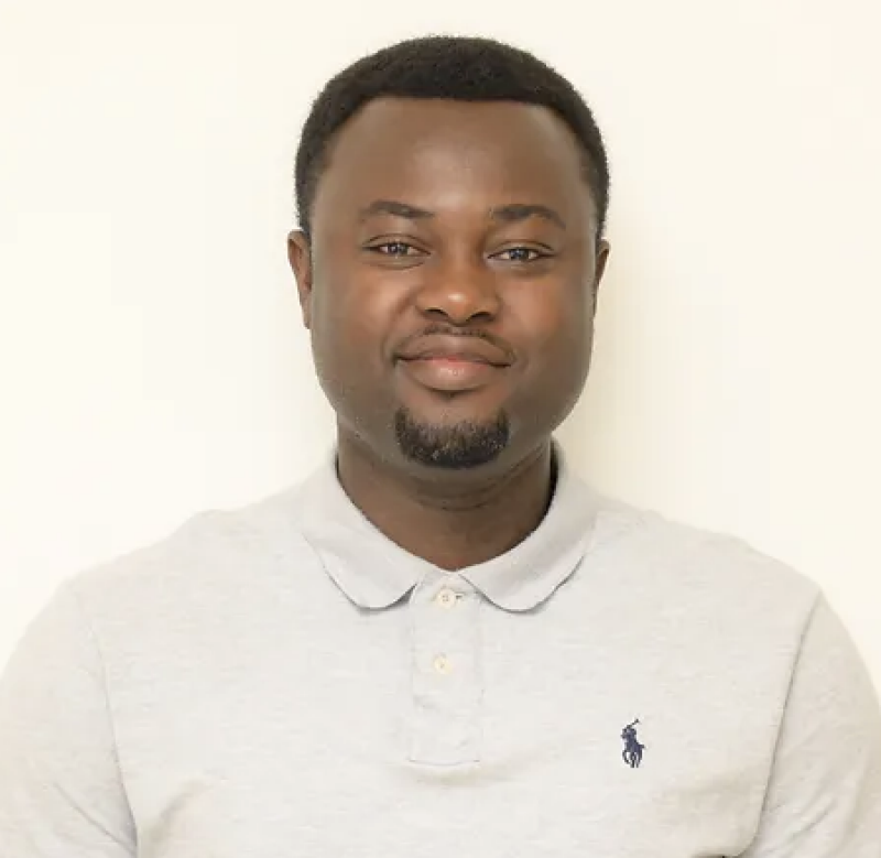 Young man wearing light tan polo shirt.