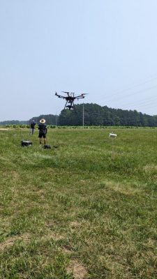 Flying a drone over tobacco fields for early pest detection.