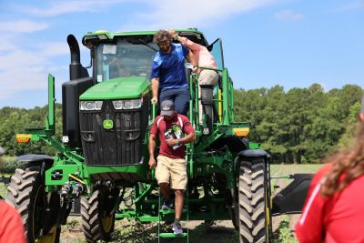 Expo attendees exit the John Deere See and Spray.