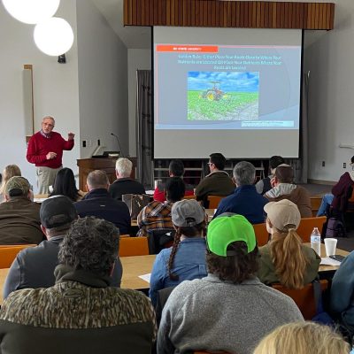Attendees listen to a professor speaking during the soil fertility workshop.