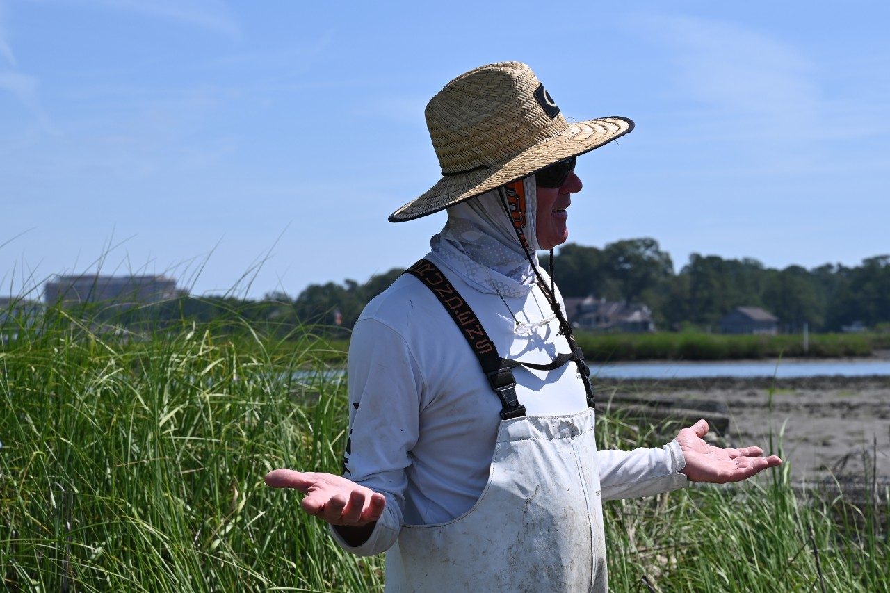 Oyster farmer standing in front of his farm site