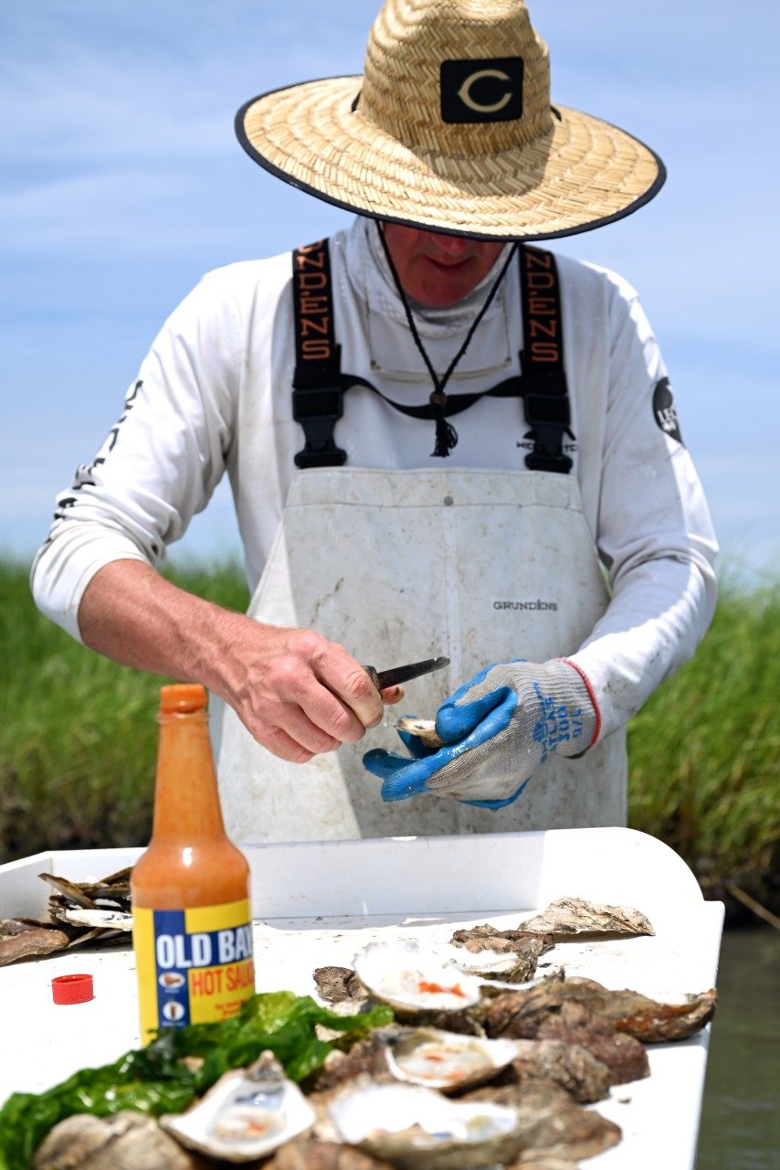 Oyster farmer preparing oysters to eat
