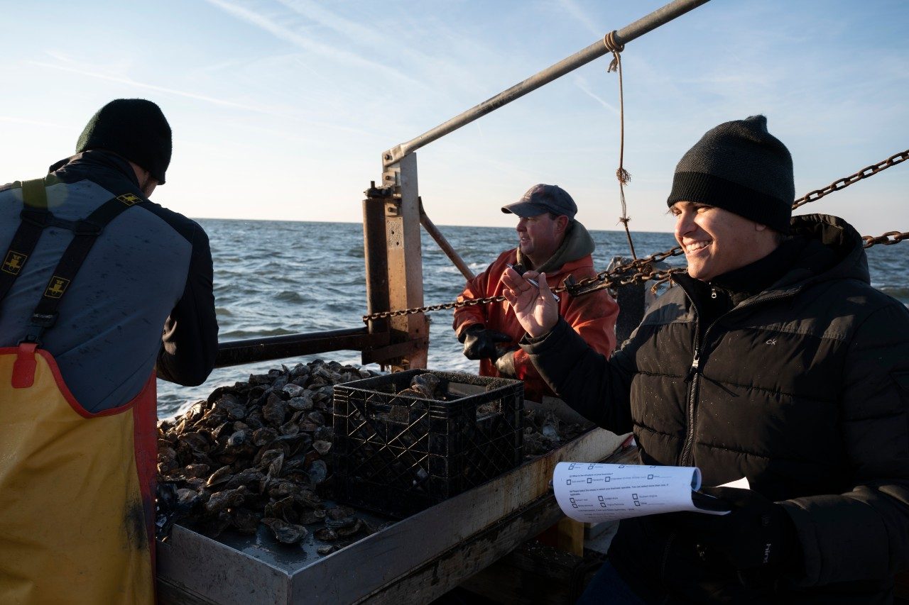 Researcher Fernando Gonçalves meets with oystermen of Tangier Island in the Chesapeake Bay.