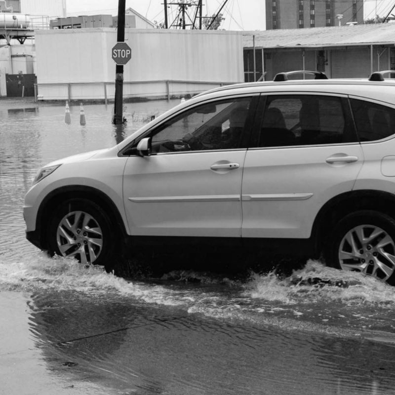 Car driving on flooded road.