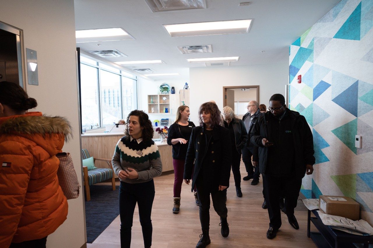 People walking through a reception area