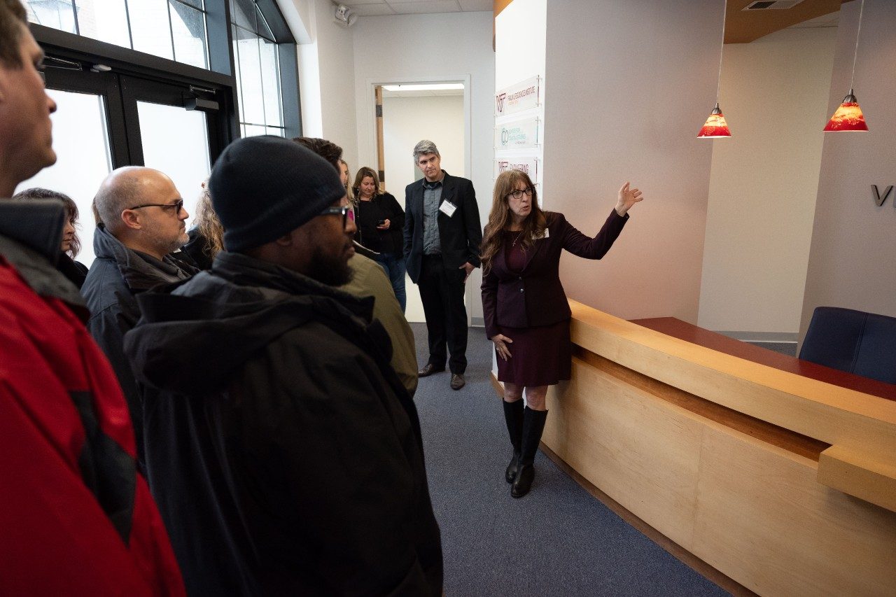 Faculty member speaking to group of listeners