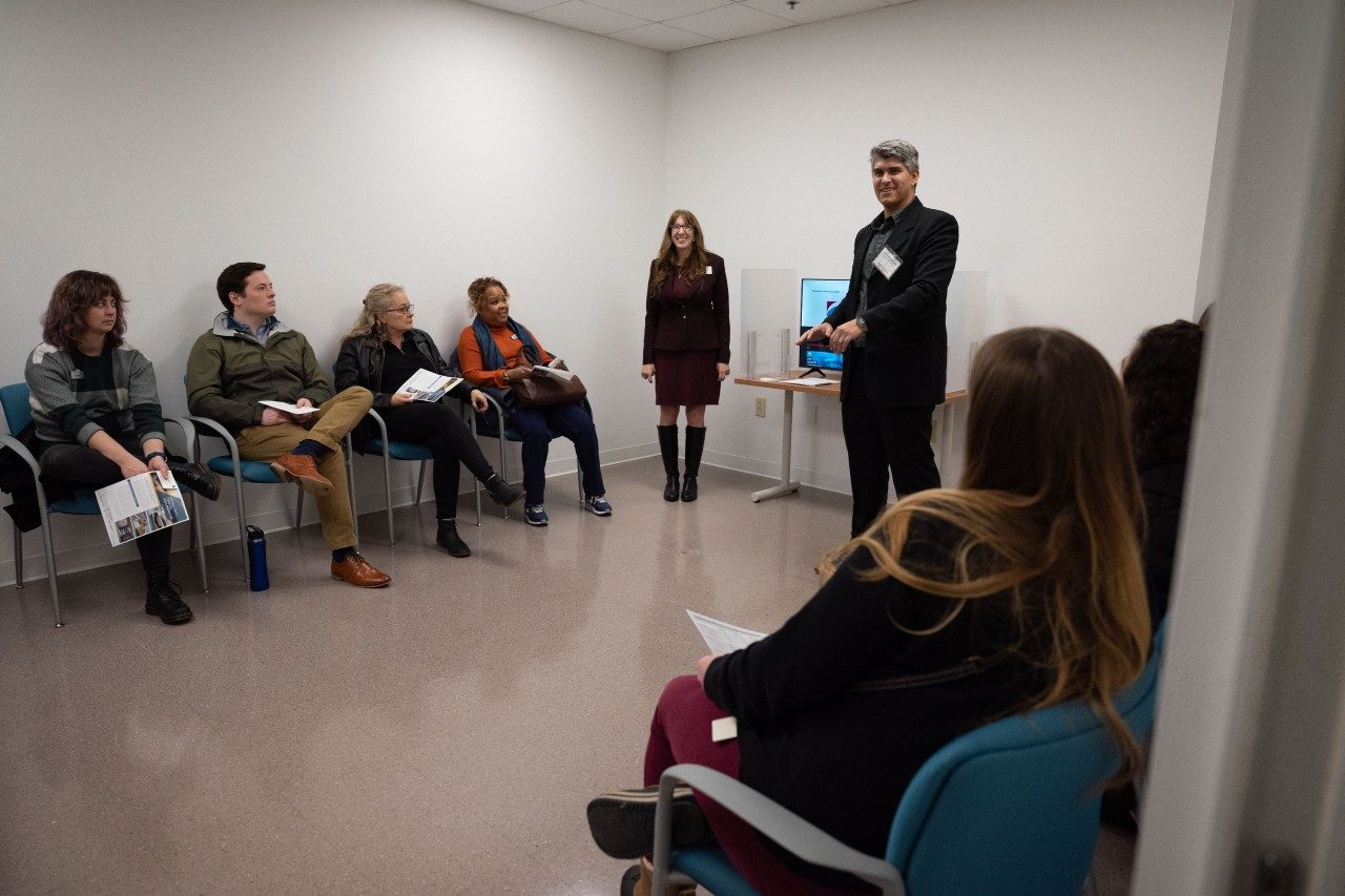 Faculty member speaking to group of listeners