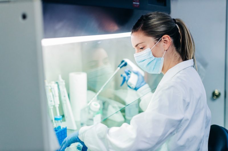 Dr. Lexi Duscher works in a cell culture hood to conduct experiments in the VSAREC lab
