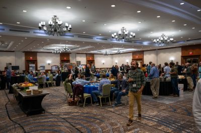 Reception hall filled with tables and seafood at aquaculture conference.