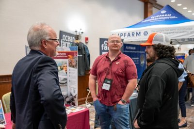 Center researchers speak with conference attendee at Virginia Aquaculture Conference.