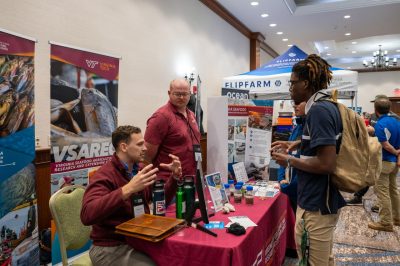 Center researchers speak with conference attendee at Virginia Aquaculture Conference.