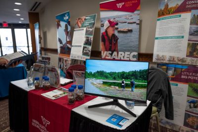 Attendees visit the Virginia Seafood AREC booth at conference