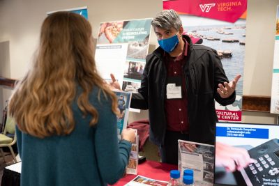 Attendees visit the Virginia Seafood AREC booth at conference